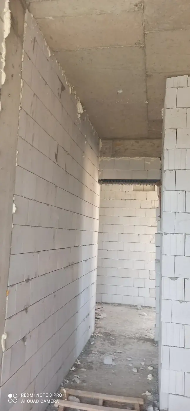 The May archive records the white masonry walls and openings at a later construction stage.