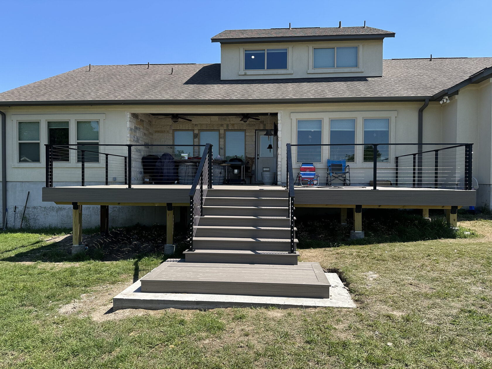 Deck rebuild with Trex composite and modern metal railing — Austin TX