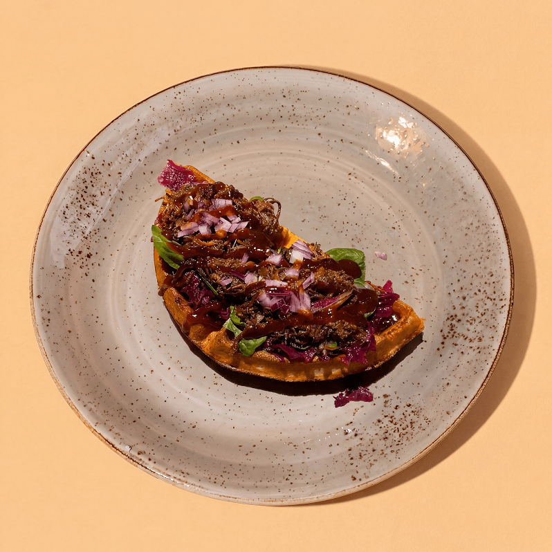 Waffle with pulled beef, red sauerkraut and BBQ sauce