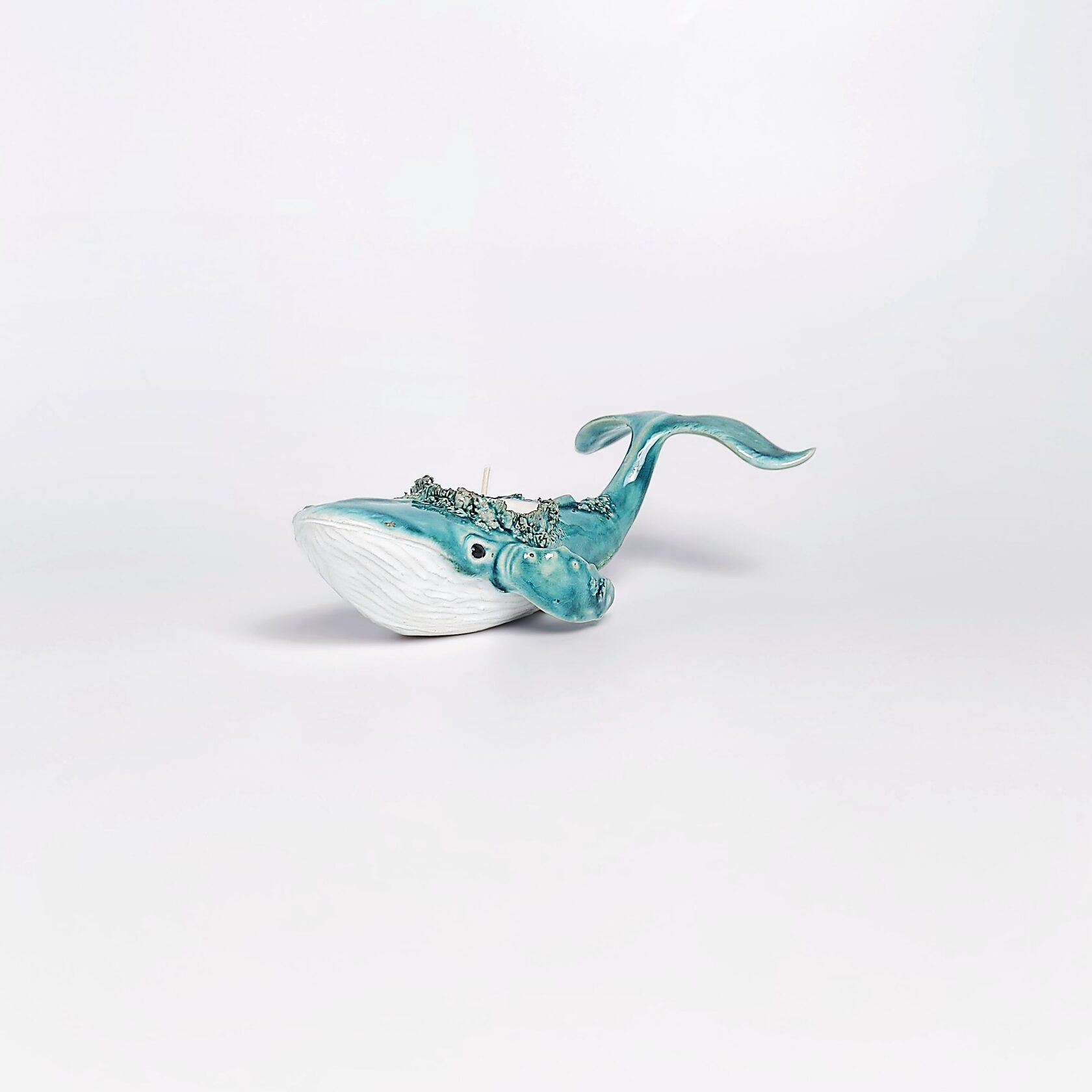 unique handmade green ceramic whale with ocean-glaze finish and detailed sculptural texture, featuring a candle inside