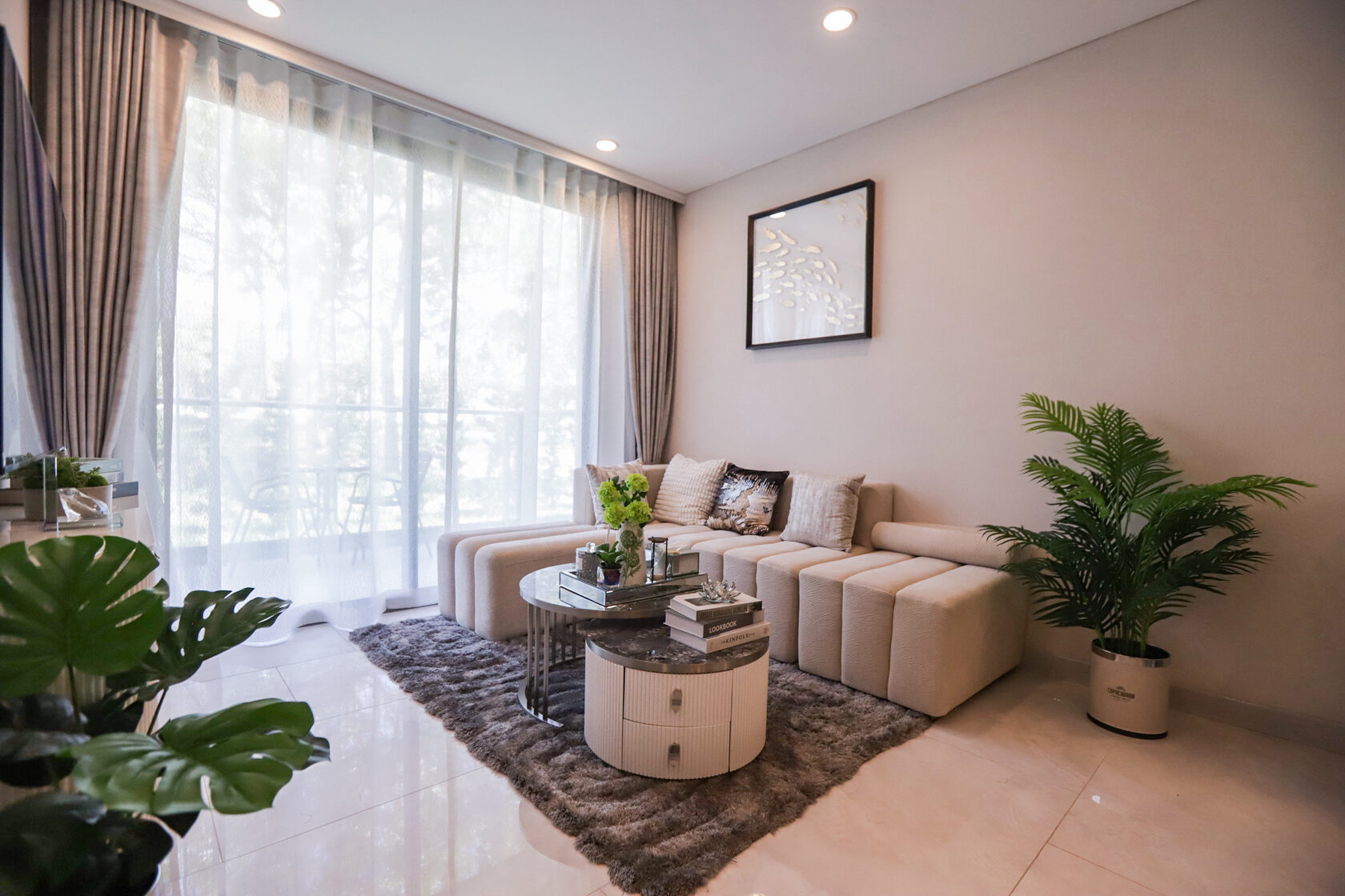 Living room with sofa and full-height windows in the Copacabana Coral Reef show unit