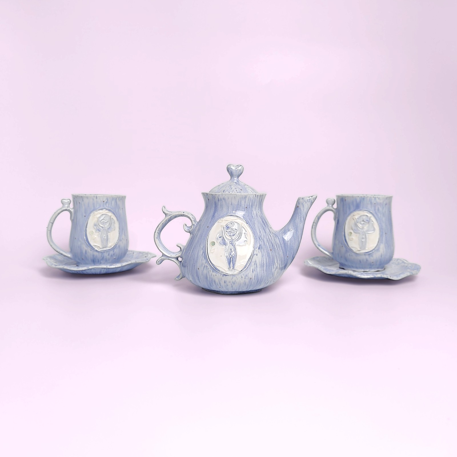 whimsical handmade ceramic tea set in soft blue glaze with forest fairy medallions — an elegant, one-of-a-kind creation