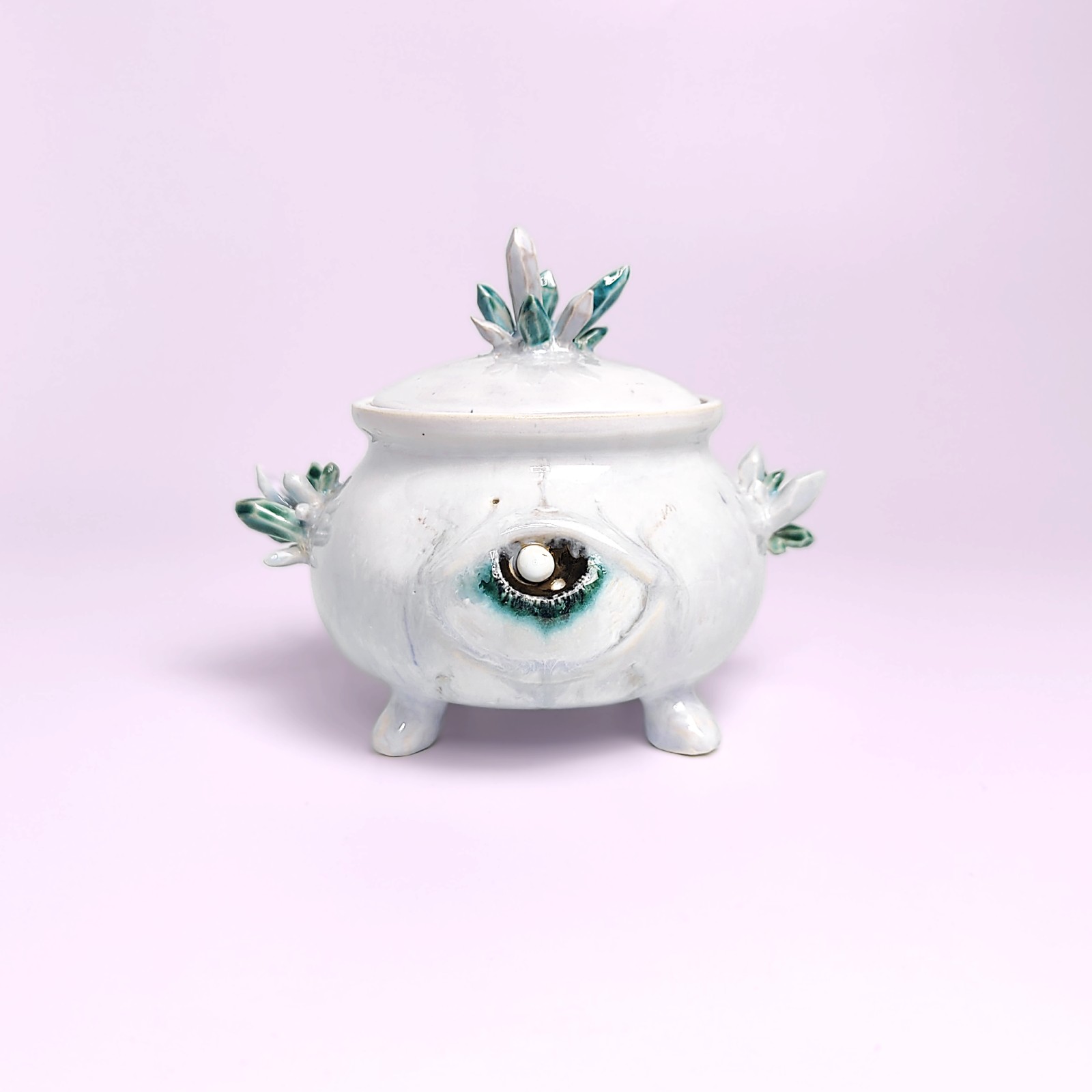 unique witchy handmade ceramic sugar bowl with a sculpted magical eye, green crystal details, and soft white glaze