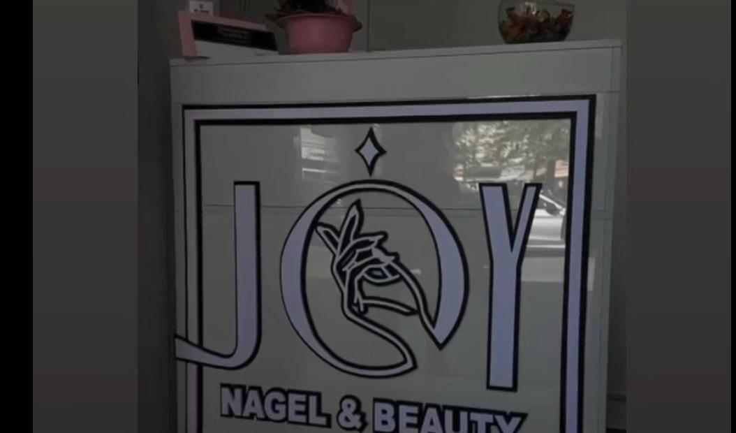 JOY Nagel & Beauty — logo on a sign — BOMBA DESIGN client