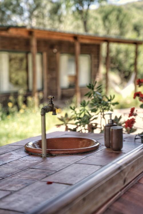 A bungalow shower with a forest view
