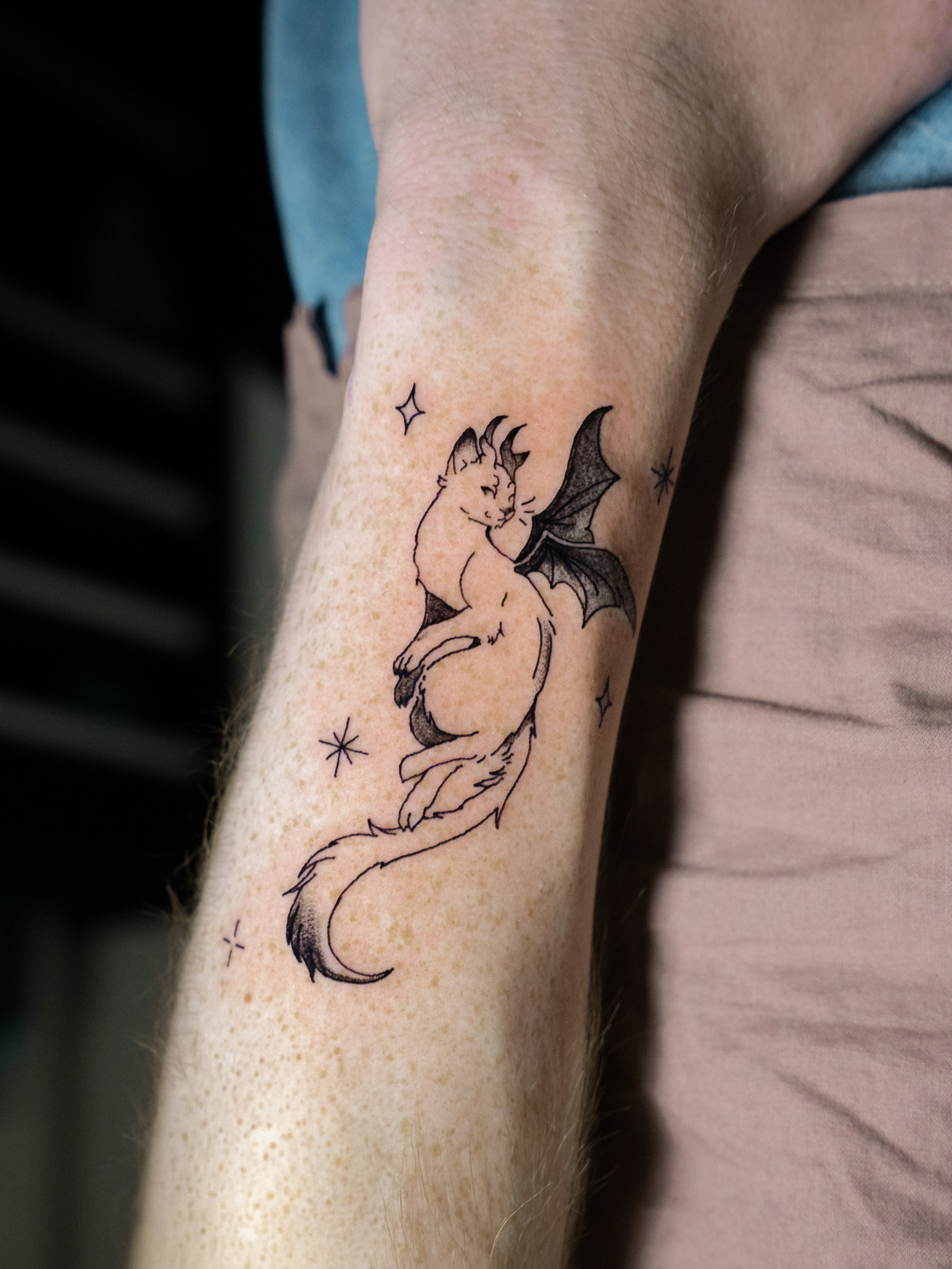 Fine line portrait tattoo on forearm