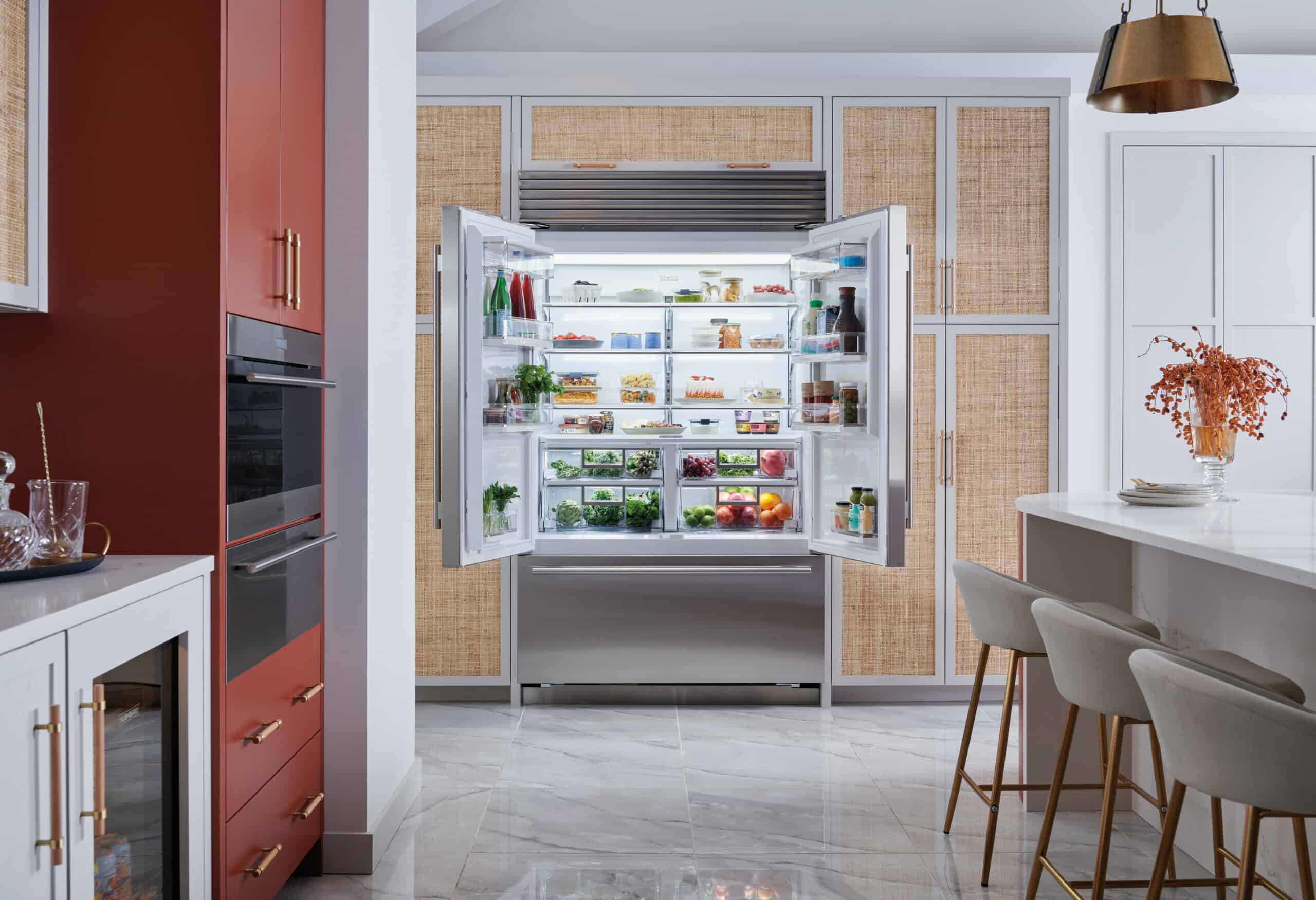 Open built-in Sub-Zero refrigerator with organized food storage
