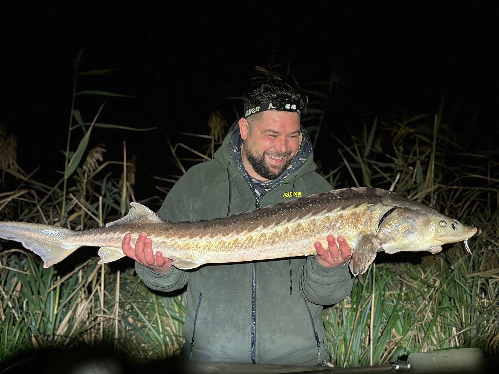 Angler using the Katran W/B 460 PRO headlamp