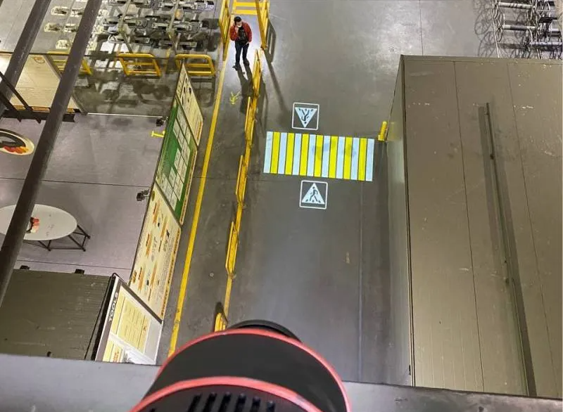 Warehouse team evaluating a projected floor marking pilot