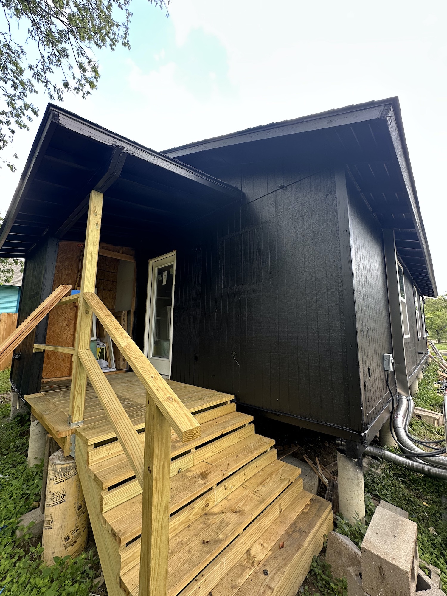 New wood porch and exterior painting at Kir Remodeling's Austin house flipping project