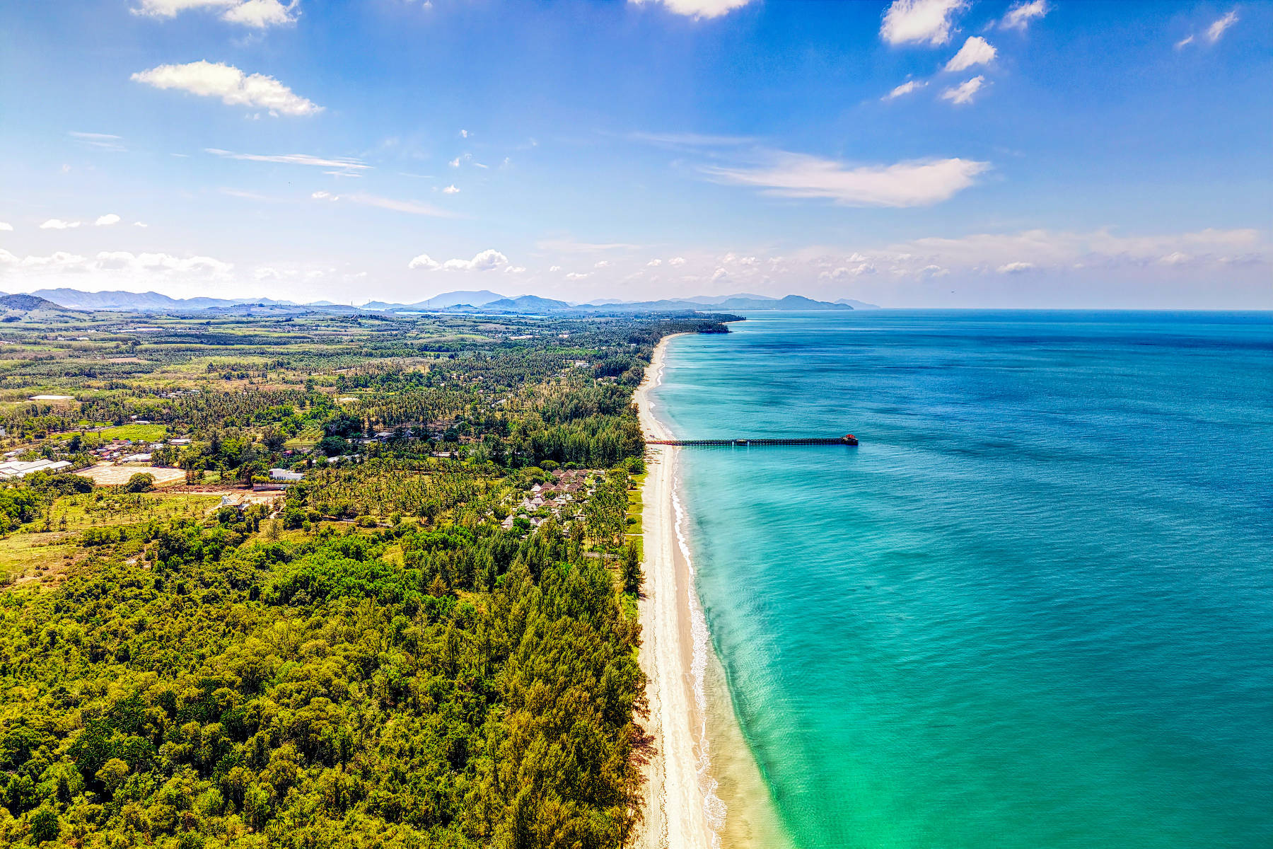 Natai Beach looking south from the public pier — empty sand and casuarina trees, Phang Nga, Thailand