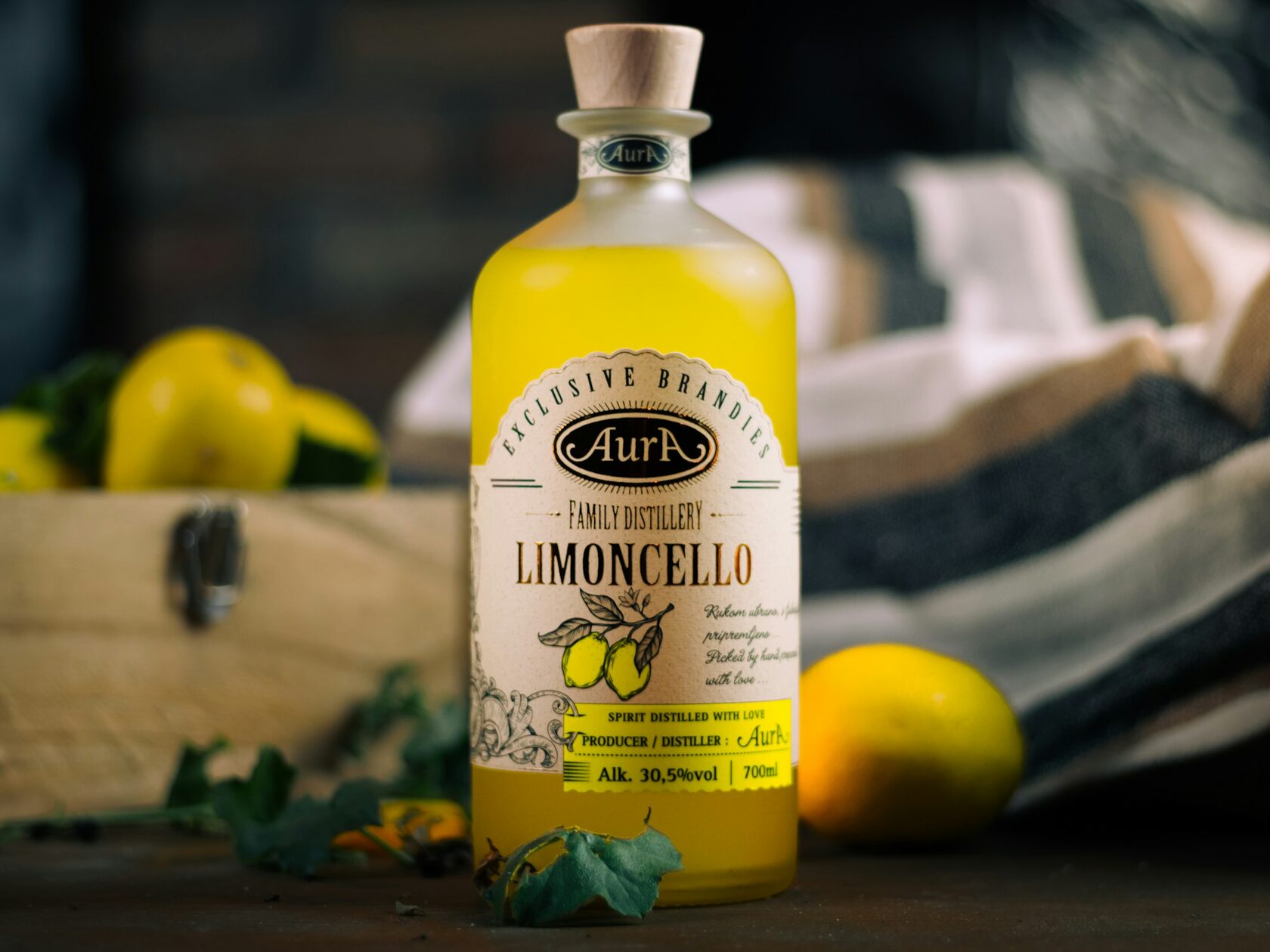 Bright lemons still on the branch and a small glass of limoncello on a terrace above the sea