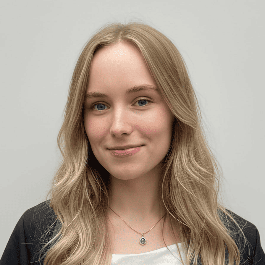 Photo of a girl with long blonde hair, smiling, wearing a white t-shirt and a black jacket.