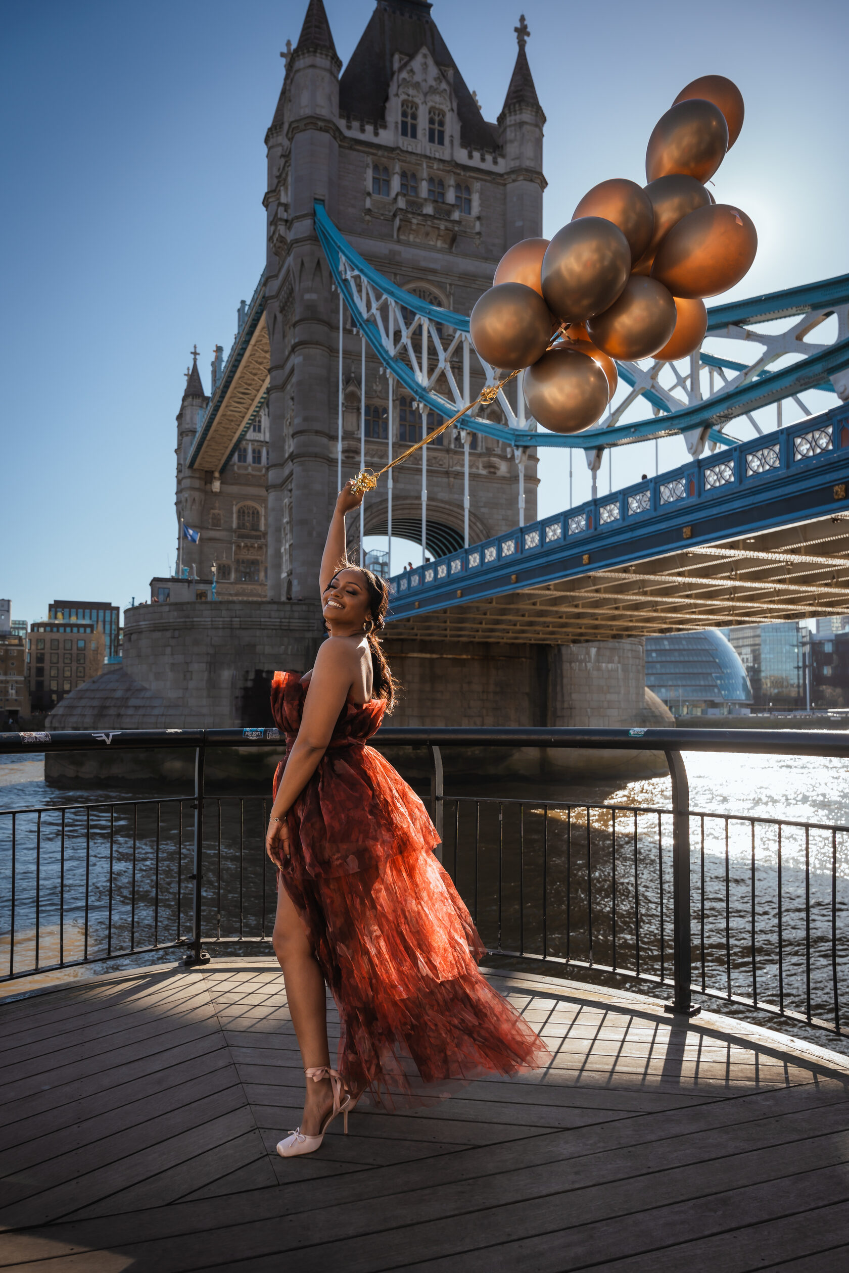 Portrait with balloons beside Tower Bridge