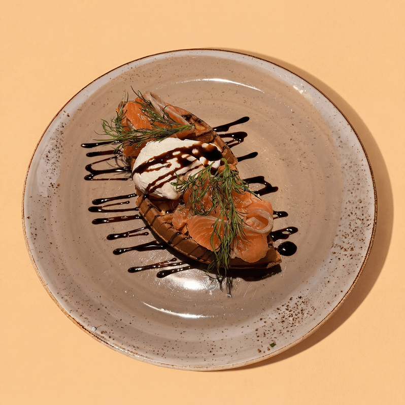 Fresh salmon waffle with egg, balsamic and dill