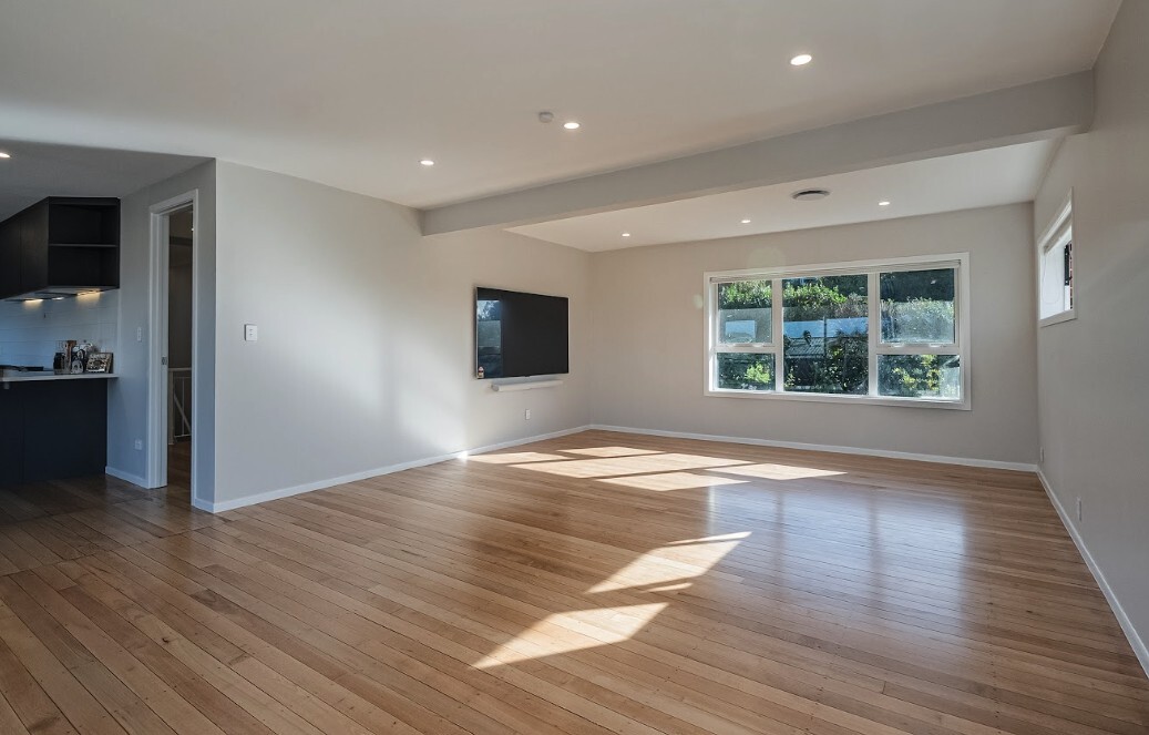 After: open Glenfield living room after the spare bedroom wall was removed