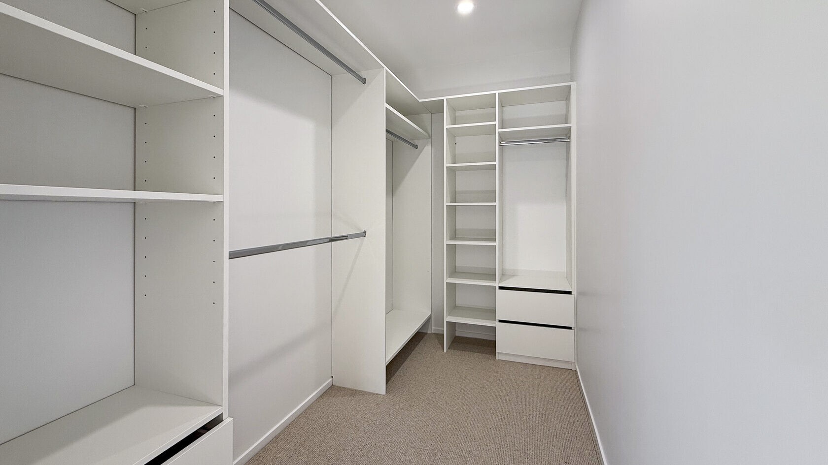 Custom walk-in wardrobe storage in the St Heliers master suite