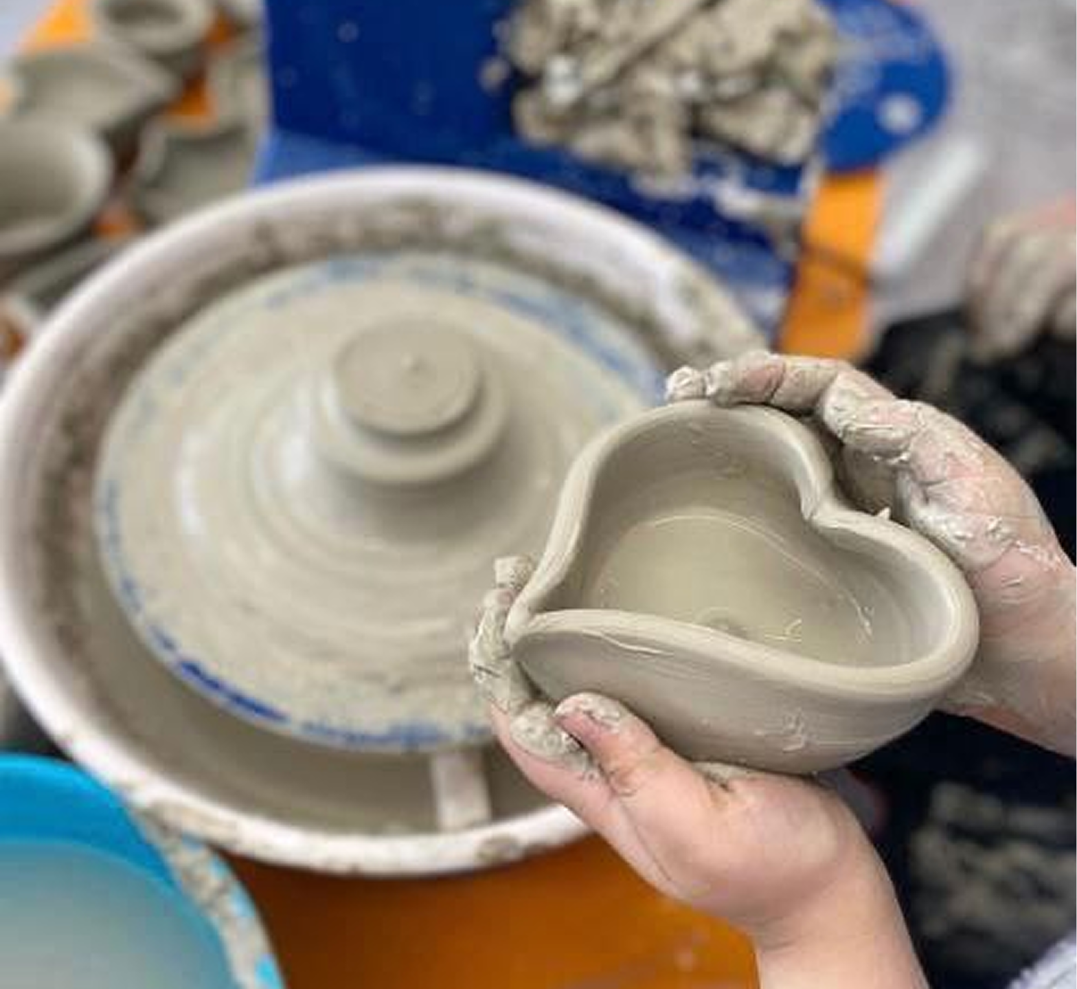 Student learning pottery wheel techniques