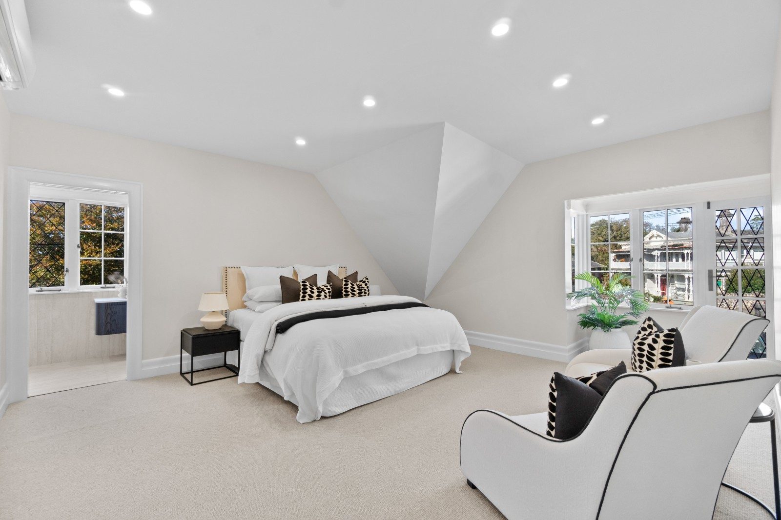 Spacious Owens Road bedroom with neutral finishes, carpet and leadlight windows