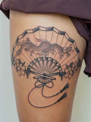 Fine line fan and dragon tattoo