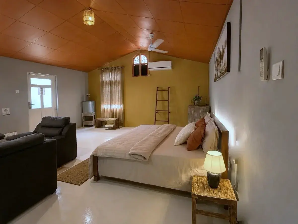 A second view of The Tack Room showing the bed, sitting area and air-conditioning at Vonfidel Ranch