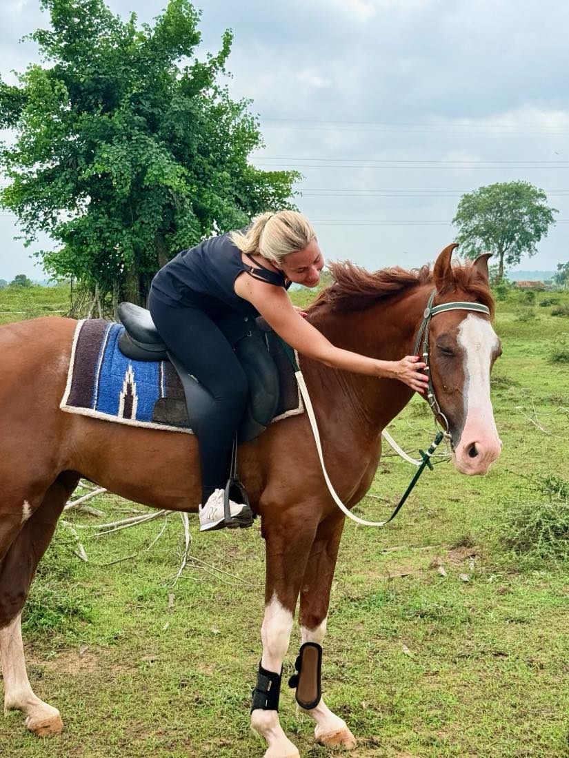 Guest gently bonding with a horse before a riding holiday at Vonfidel Ranch in Sri Lanka