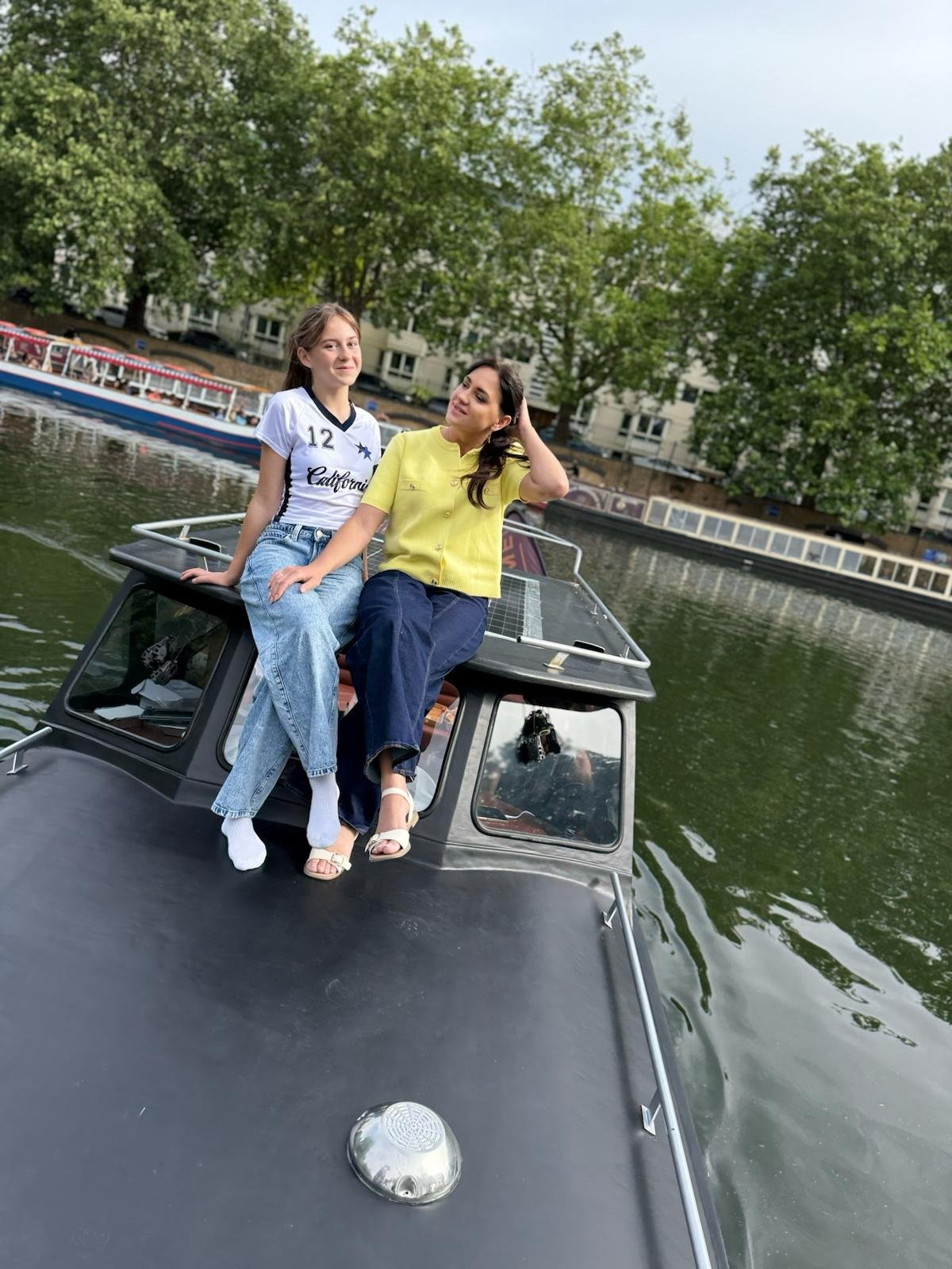 Mother and daughter on boat bow