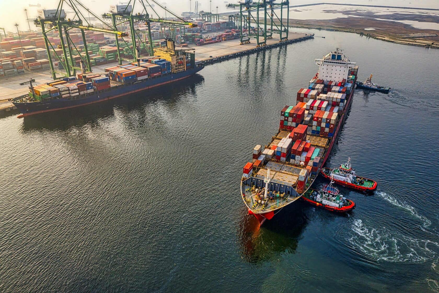 Modern commercial port with stacked shipping containers and cargo infrastructure