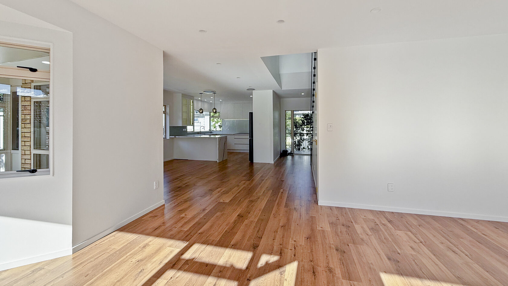 Completed St Heliers open-plan kitchen and living area with timber flooring and renewed finishes