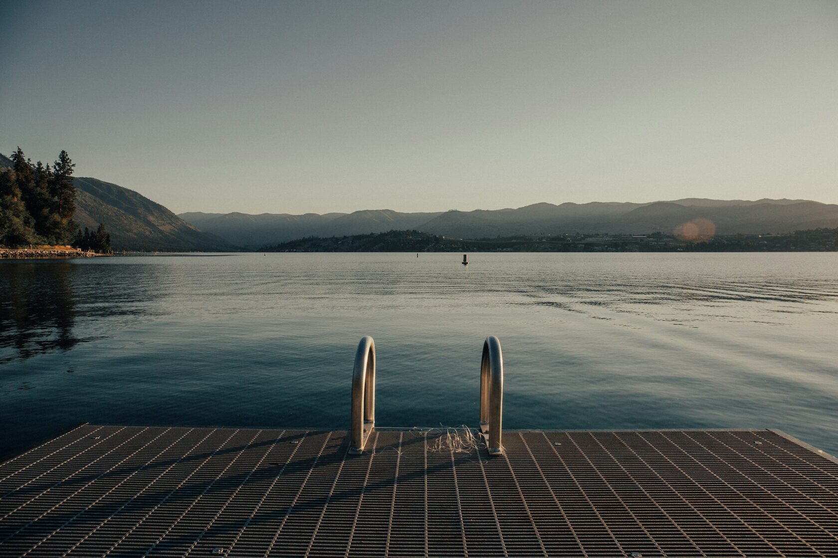 Resort-style pool overlooking Kerr Lake at sunset