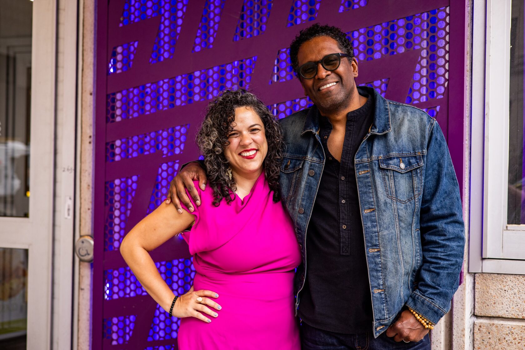 Leigh Goldenberg and Lindsay Smiling in front of the Wilma's purple facade