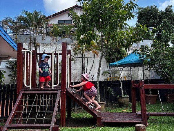 Children climbing on the wooden playground