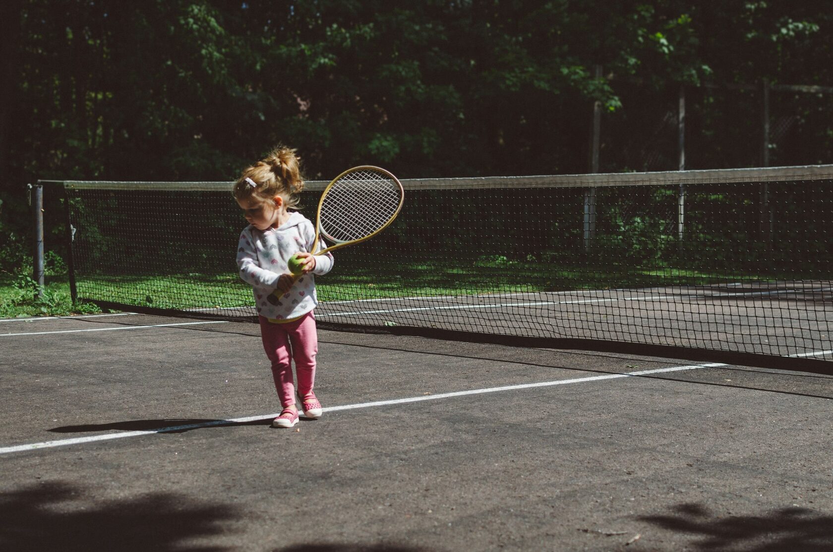 Young child learning tennis fundamentals