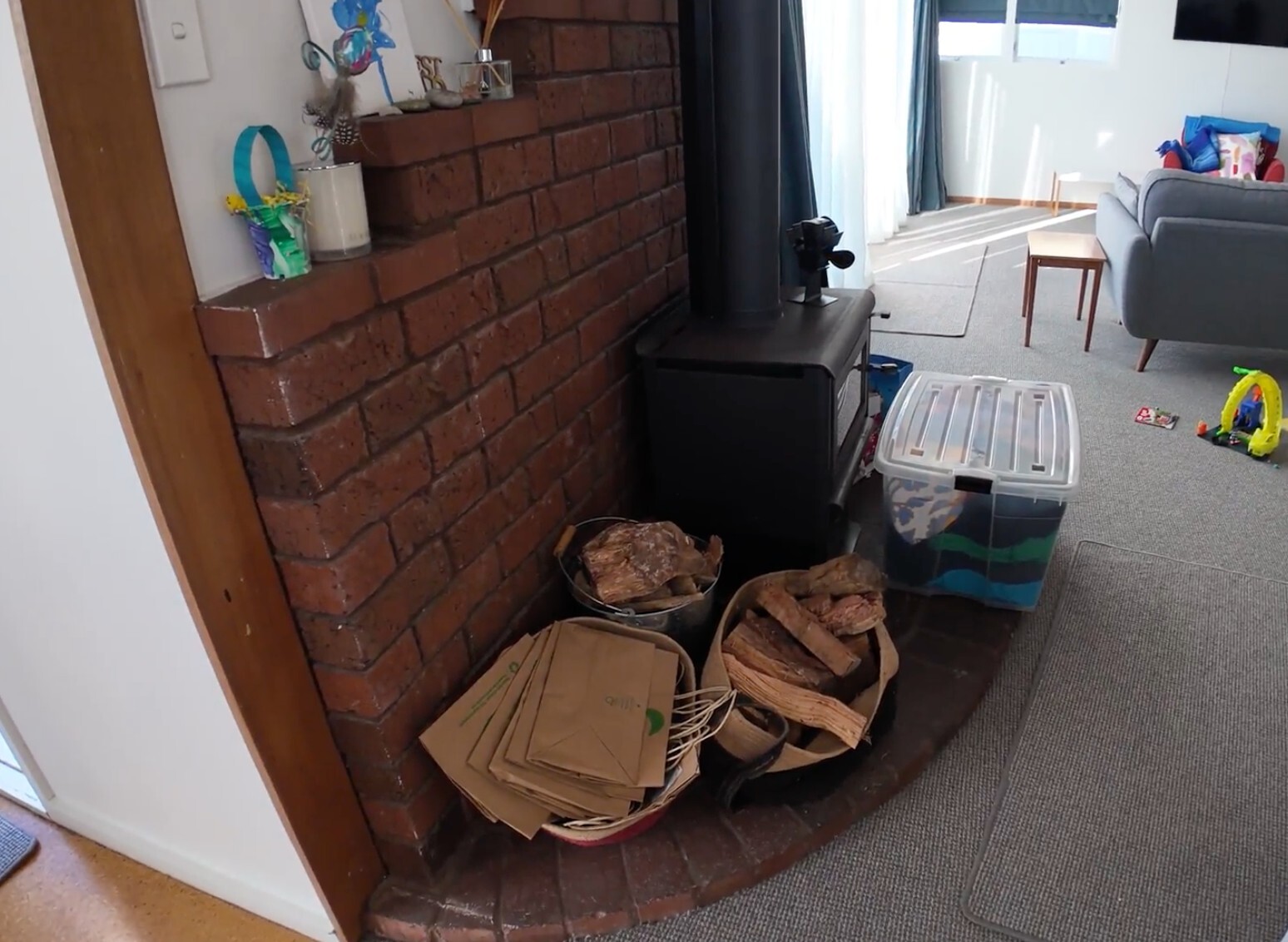 Before: original brick fireplace and black wood burner in the Hillcrest living room