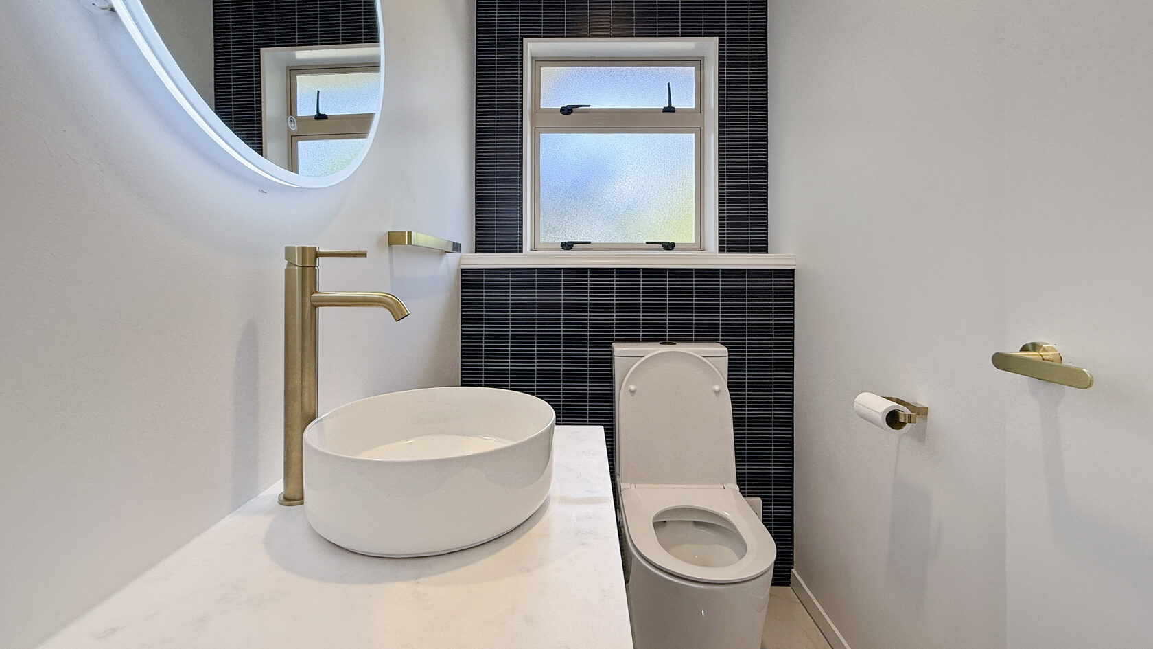 Close view of the powder room vessel sink and brushed brass tap in St Heliers.