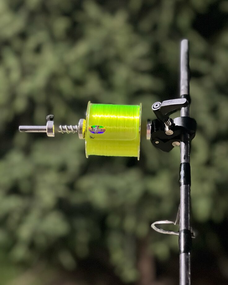 Katran line spooling tool driven by a cordless drill, stripping old line onto the spool