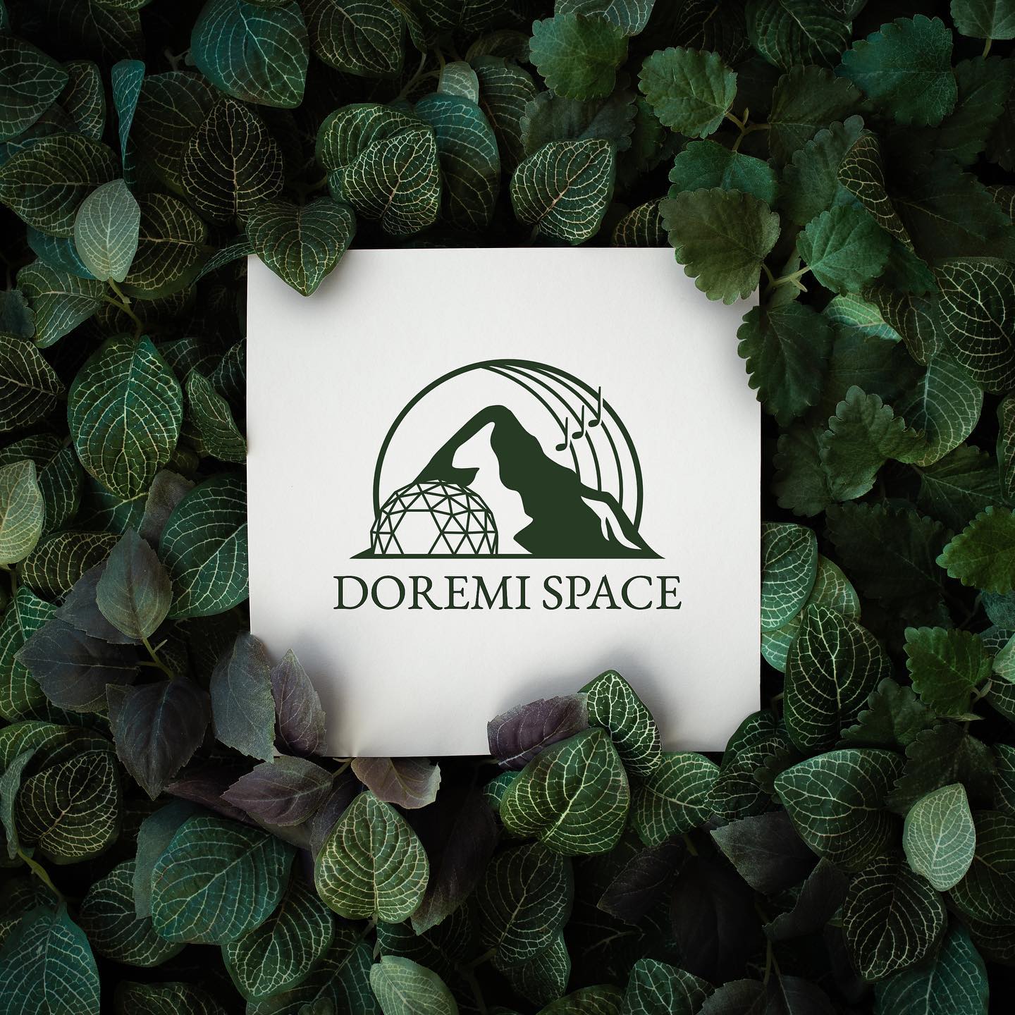 DoReMi Space dome hotel logo – a mountain, a dome and notes