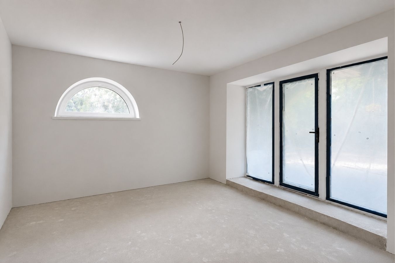 Current unfinished arched-window guest room