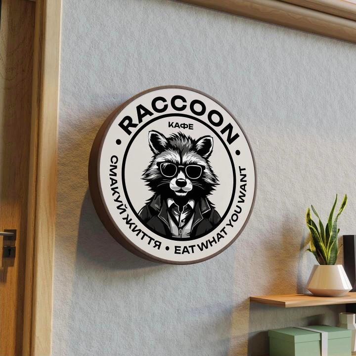 Round RACCOON café sign on a wall