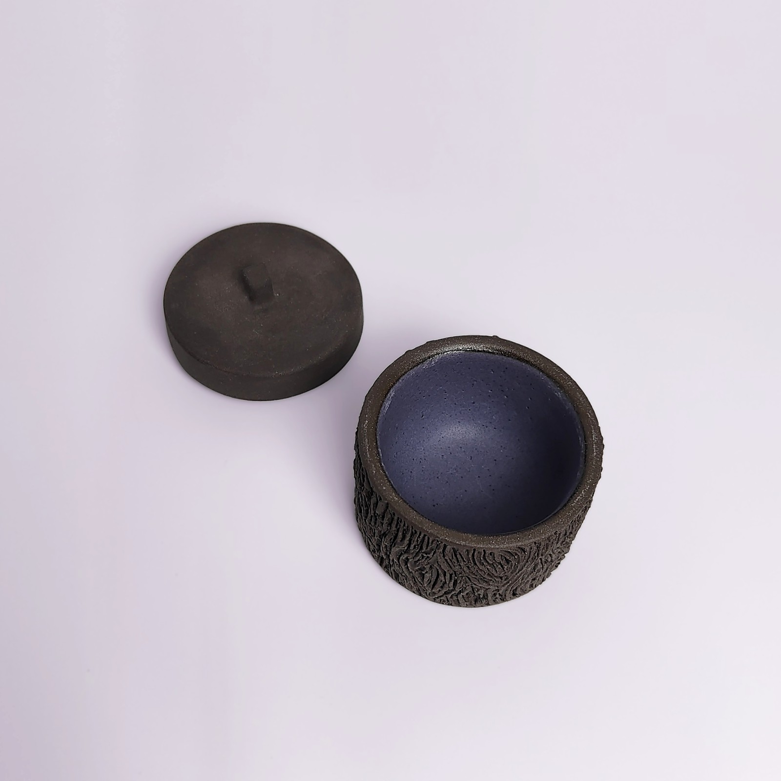 dark witchy-style ceramic box with carved wood-like texture and mystical violet glaze