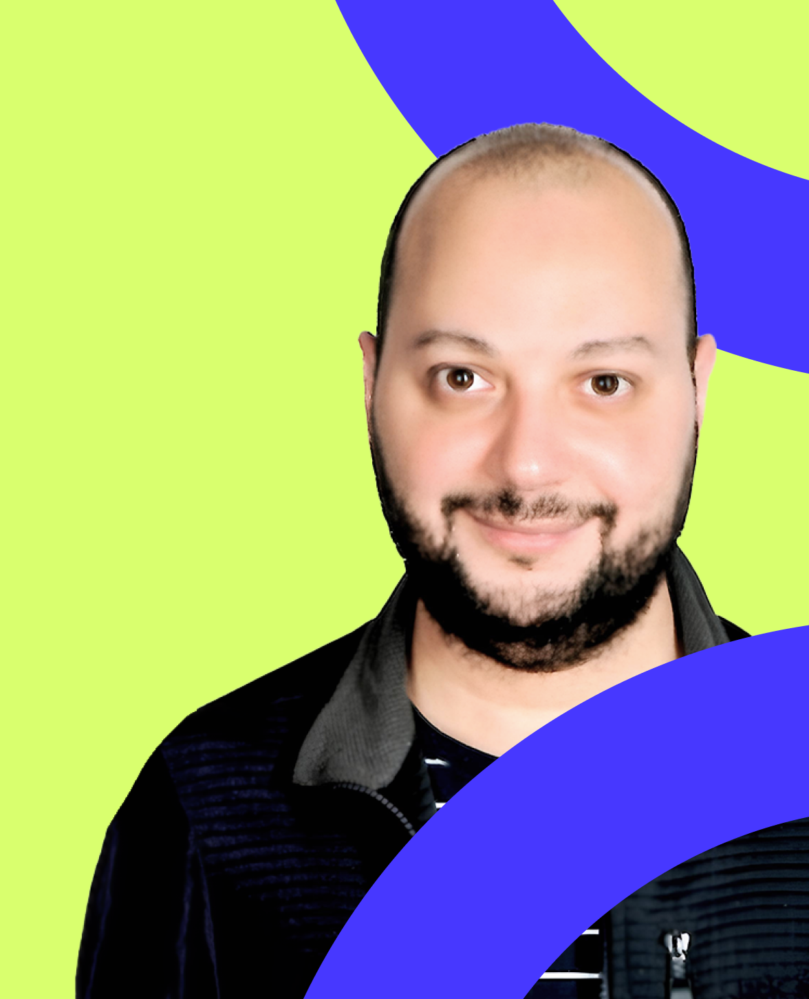 A man with a beard and a moustache smiles warmly (Mohamed Hassan). 