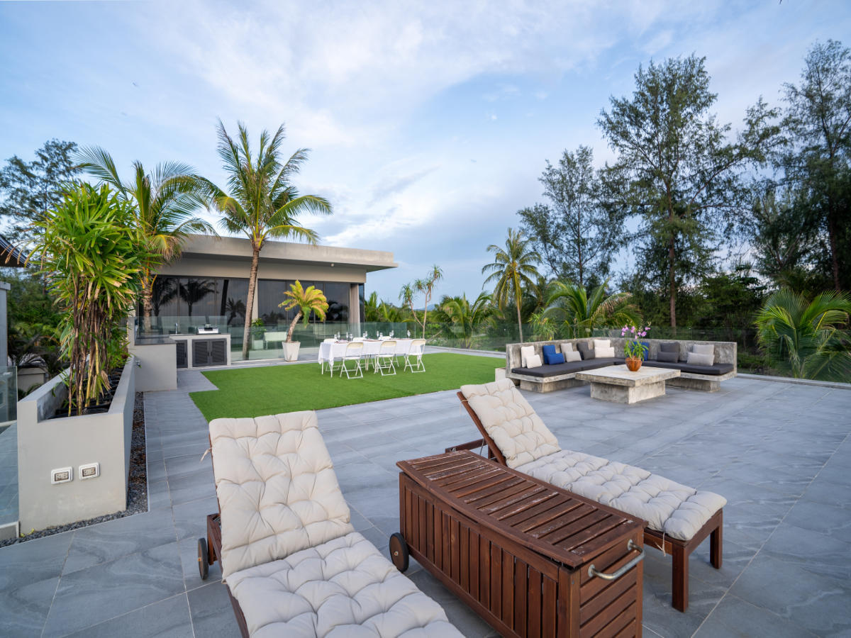 Upstairs terrace with pool chairs and dining table, Villa 57