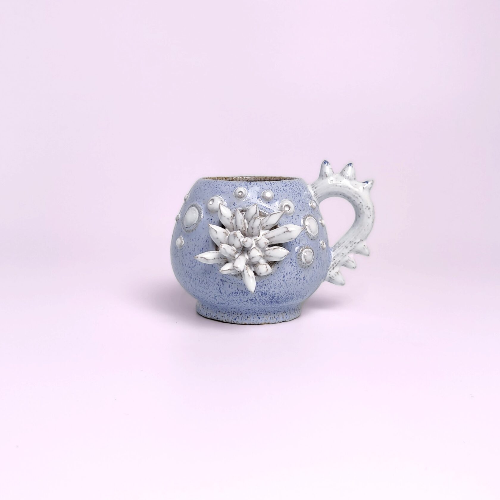 Unique handmade fairy-tale ceramic tea set shaped like a whimsical crystal-covered little monster, featuring a sculptural teapot and two matching cups with saucers