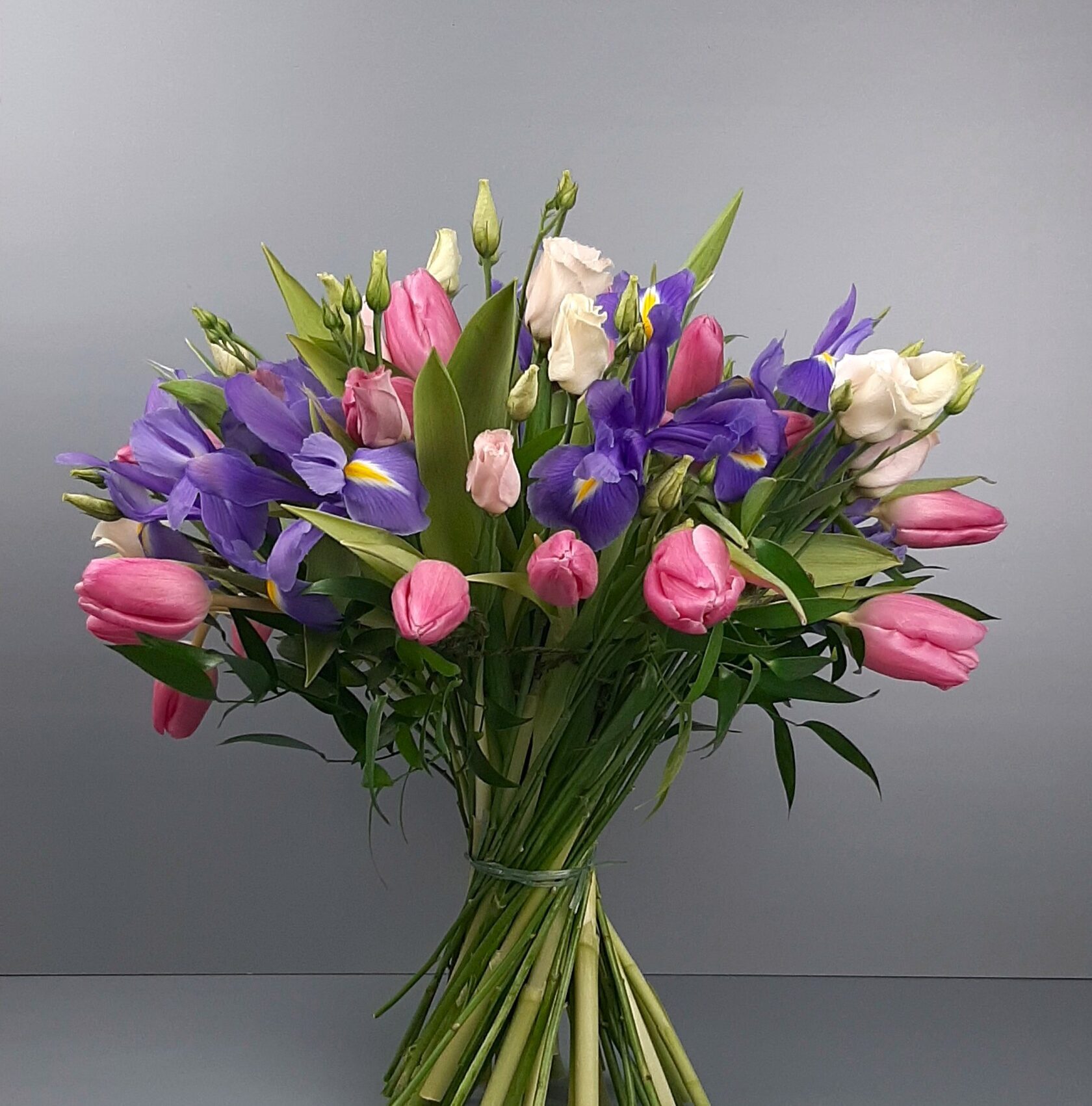 spring bouquet with tulips, irises, and seasonal flowers