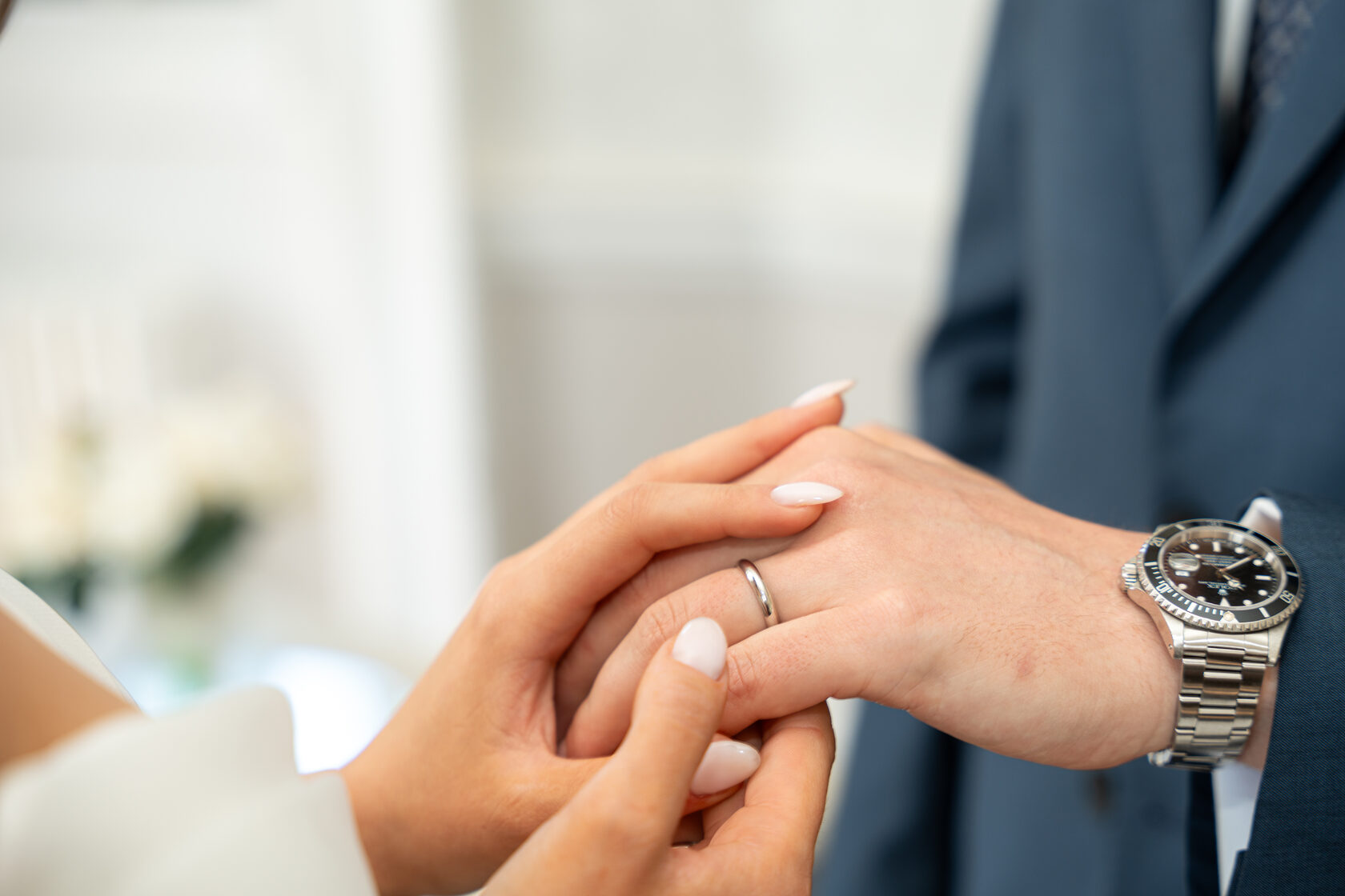 Close-up of a couple exchanging wedding rings