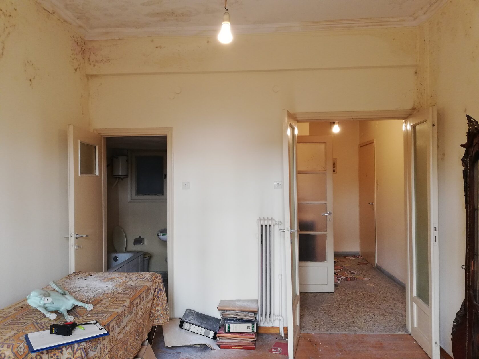 Main room before renovation, 2020 — dim, north-facing, half the square footage in storage