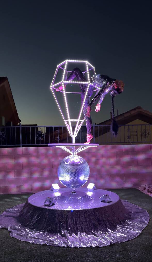 Disco Luxe Platform with LED diamond prop glowing at night