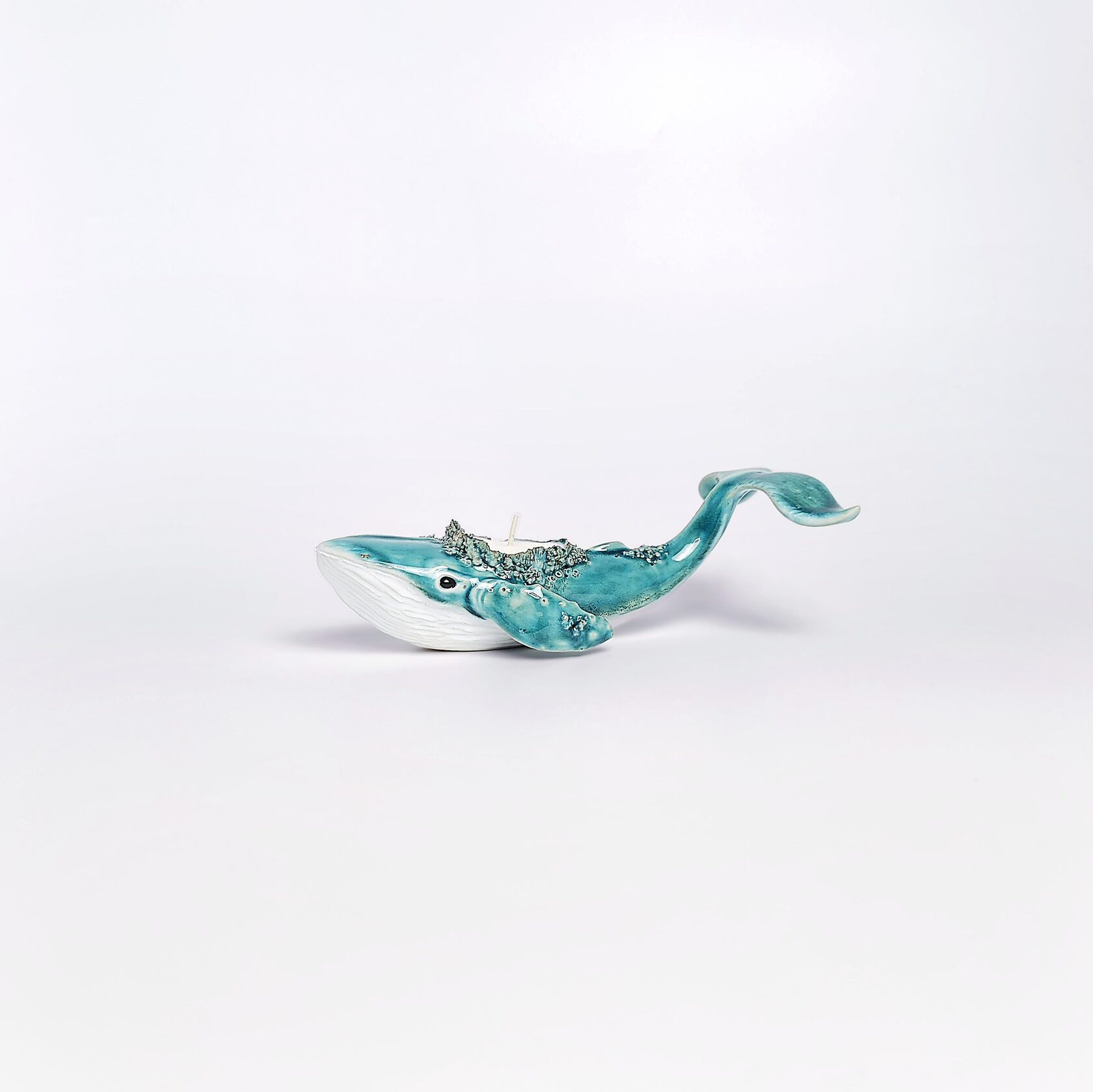 unique handmade green ceramic whale with ocean-glaze finish and detailed sculptural texture, featuring a candle inside
