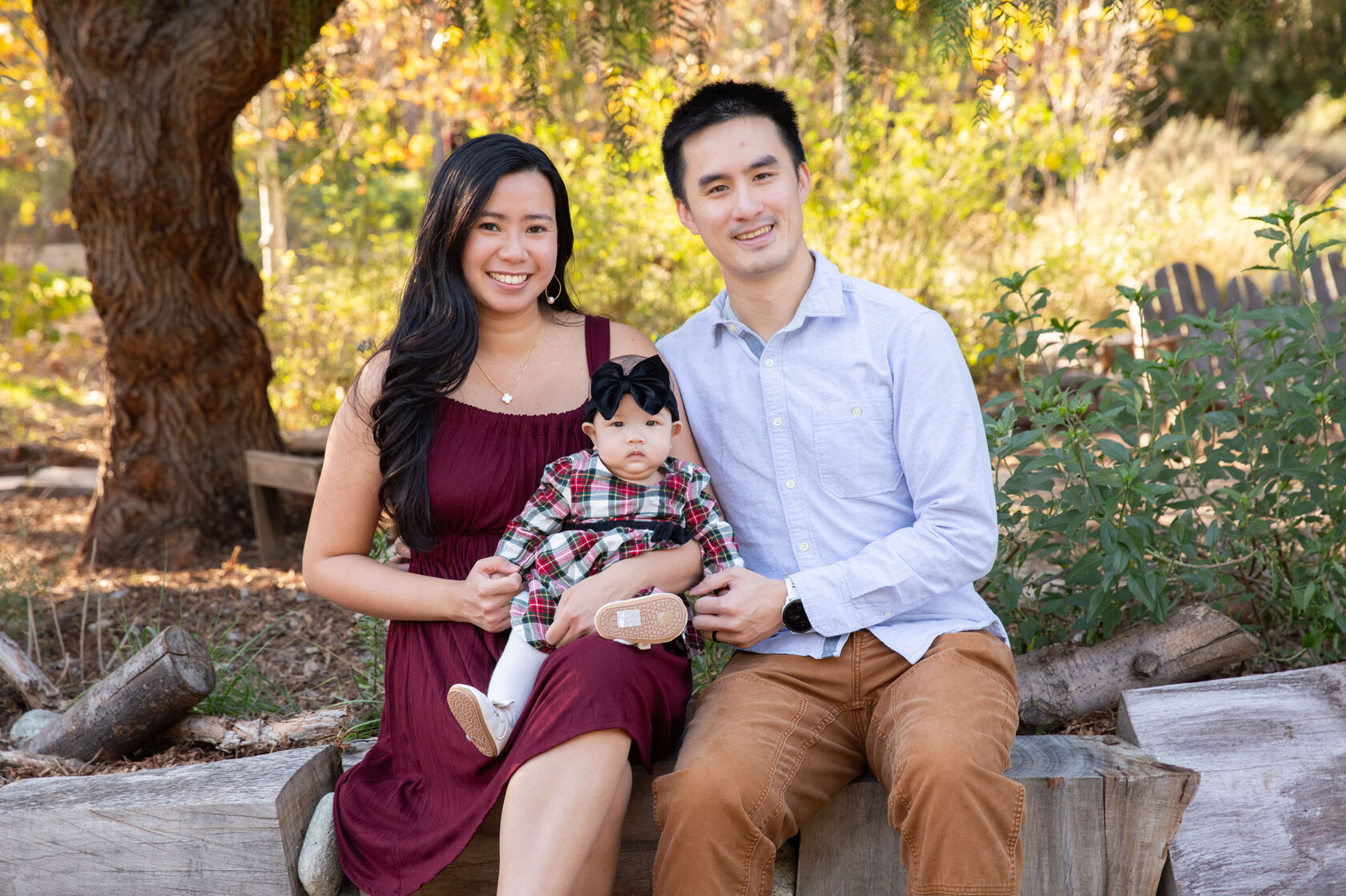 Family laughing together outdoors in warm light