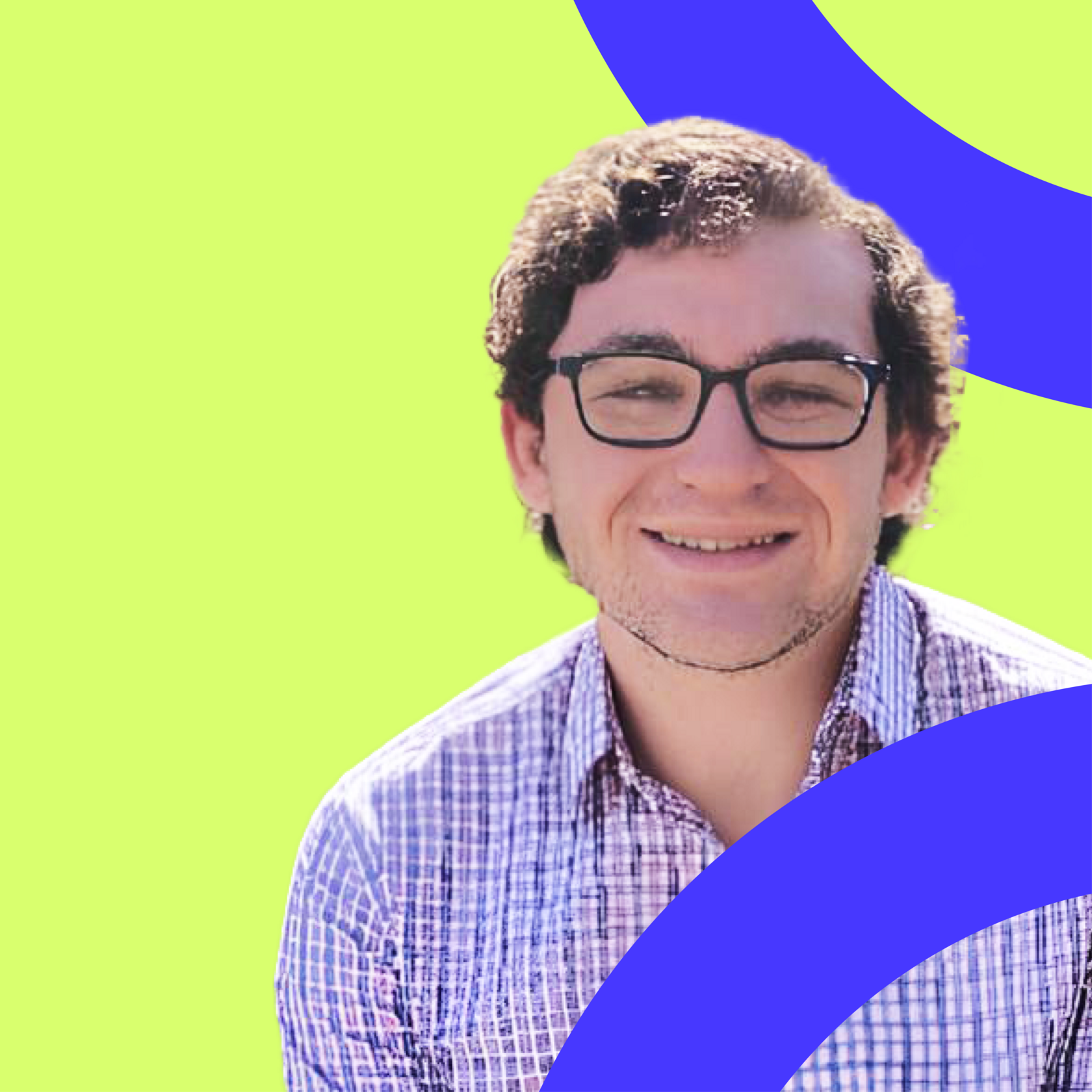 A man wearing glasses kindly smiling (Sam Giddins).